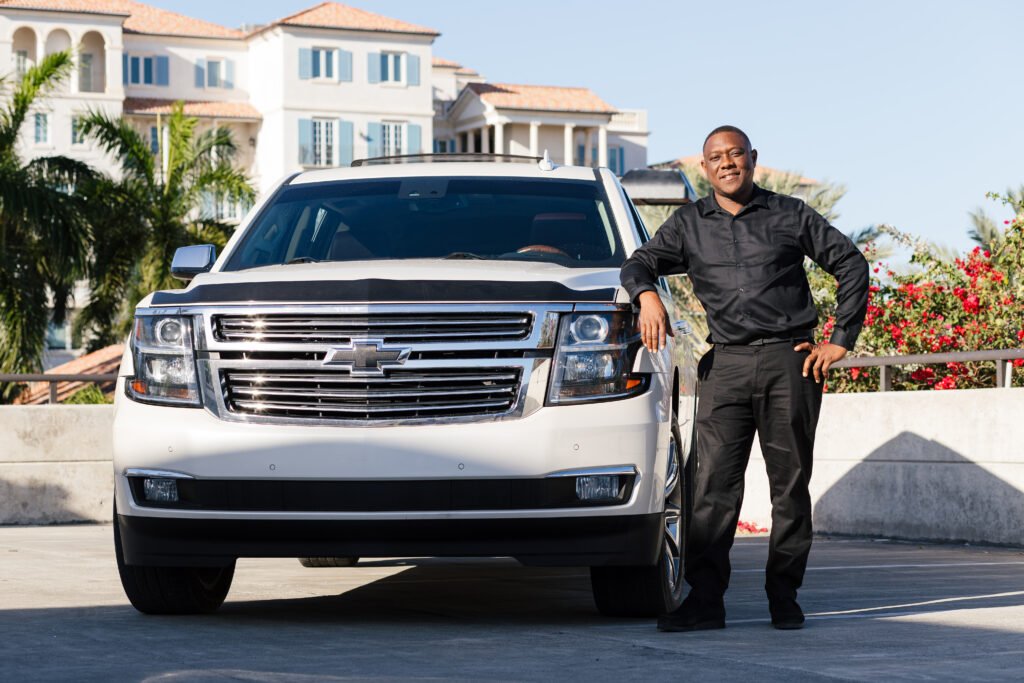 Secure Taxi driver standing beside a private SUV